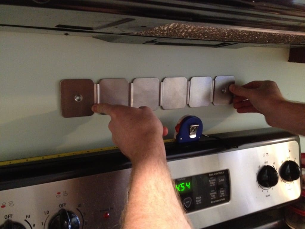 A photo of the magnetic spice rack being installed.