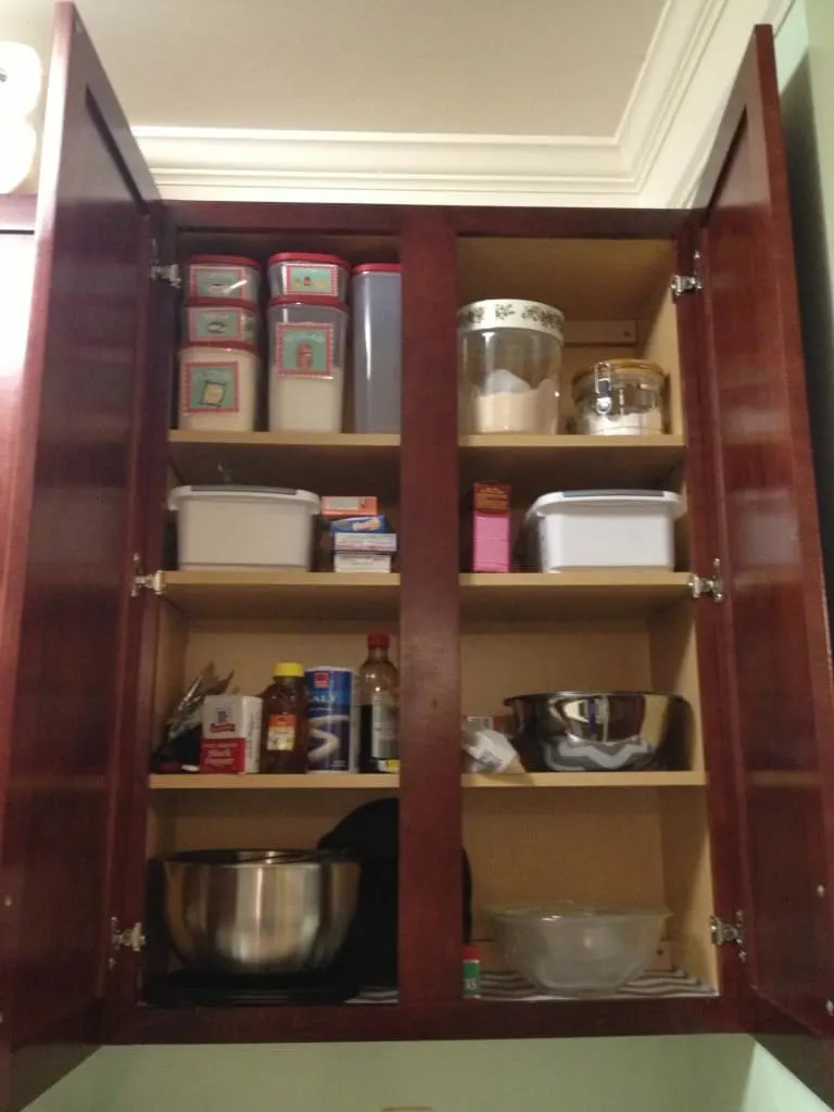 A photo of an open baking cabinet with everything carefully organized. An example of great baking cabinet organization. 