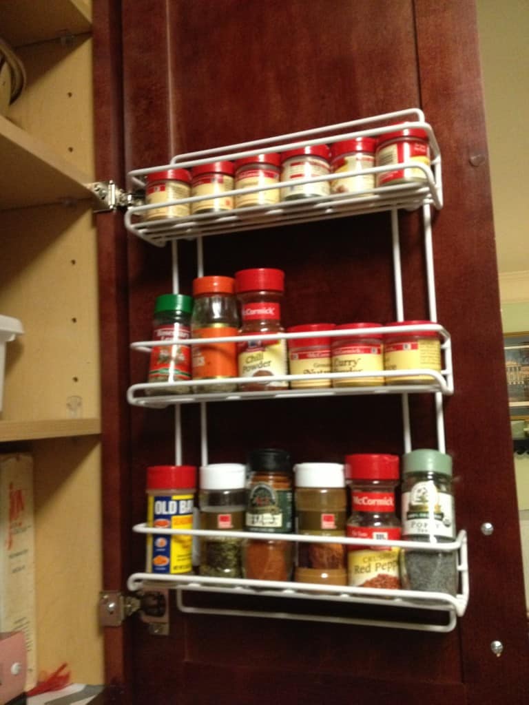 A photo of the inside of the right door, with a hanging spice rack. A great way of freeing baking cabinet space. 