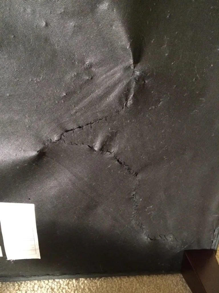 A photo of the tear in the underside of the couch having been repaired. 