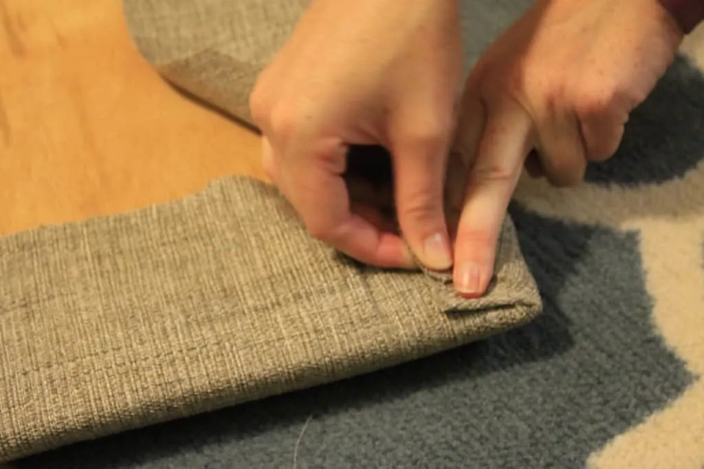 A photo of the upholstery fabric being carefully folded at the corners like gift wrapping. 