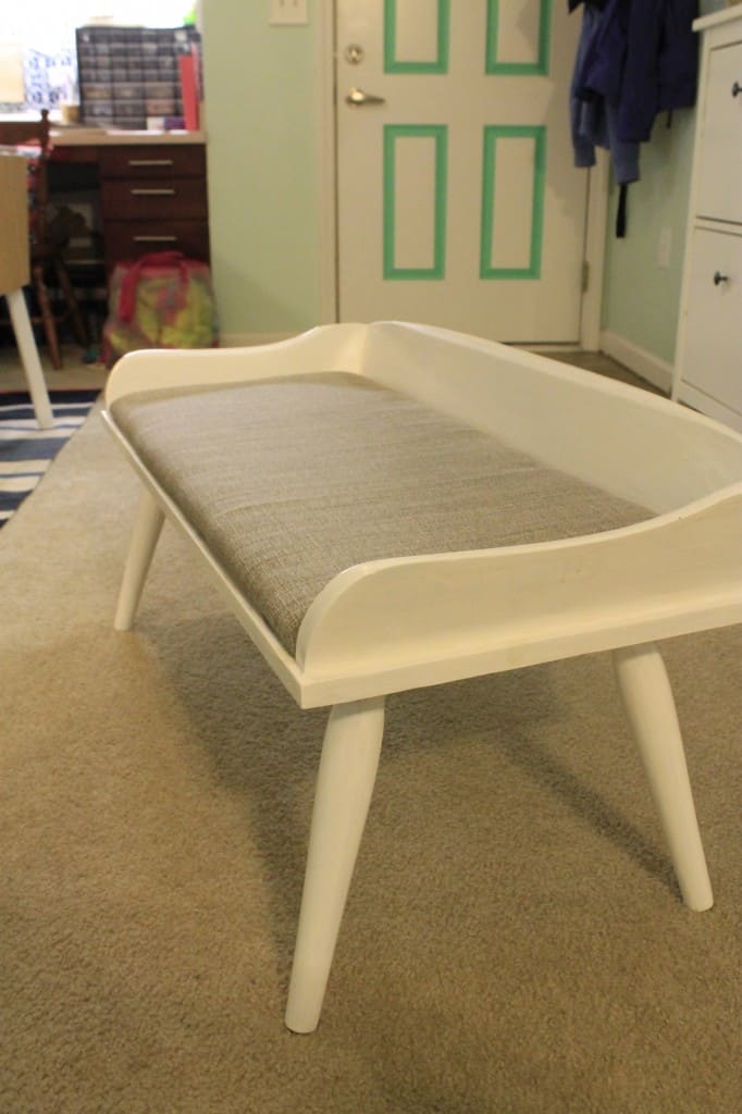 A photo of the finished reupholstered bench.