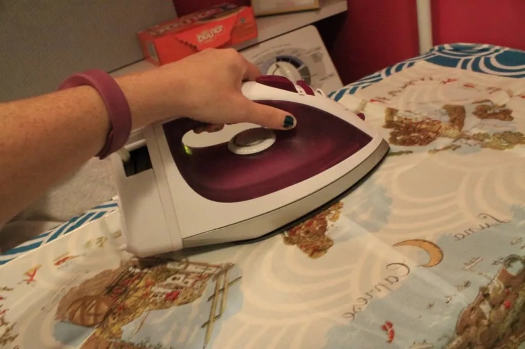A photo of the scarf being ironed with a hot clothes iron