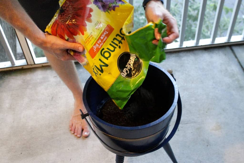 A photo of the soil being added to the planter. 