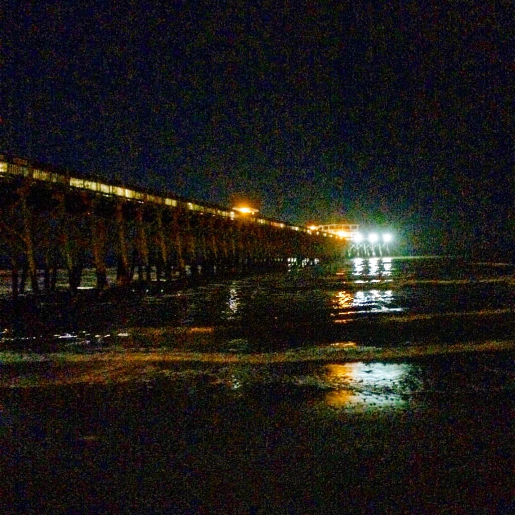 Folly beach pier at night - charleston crafted