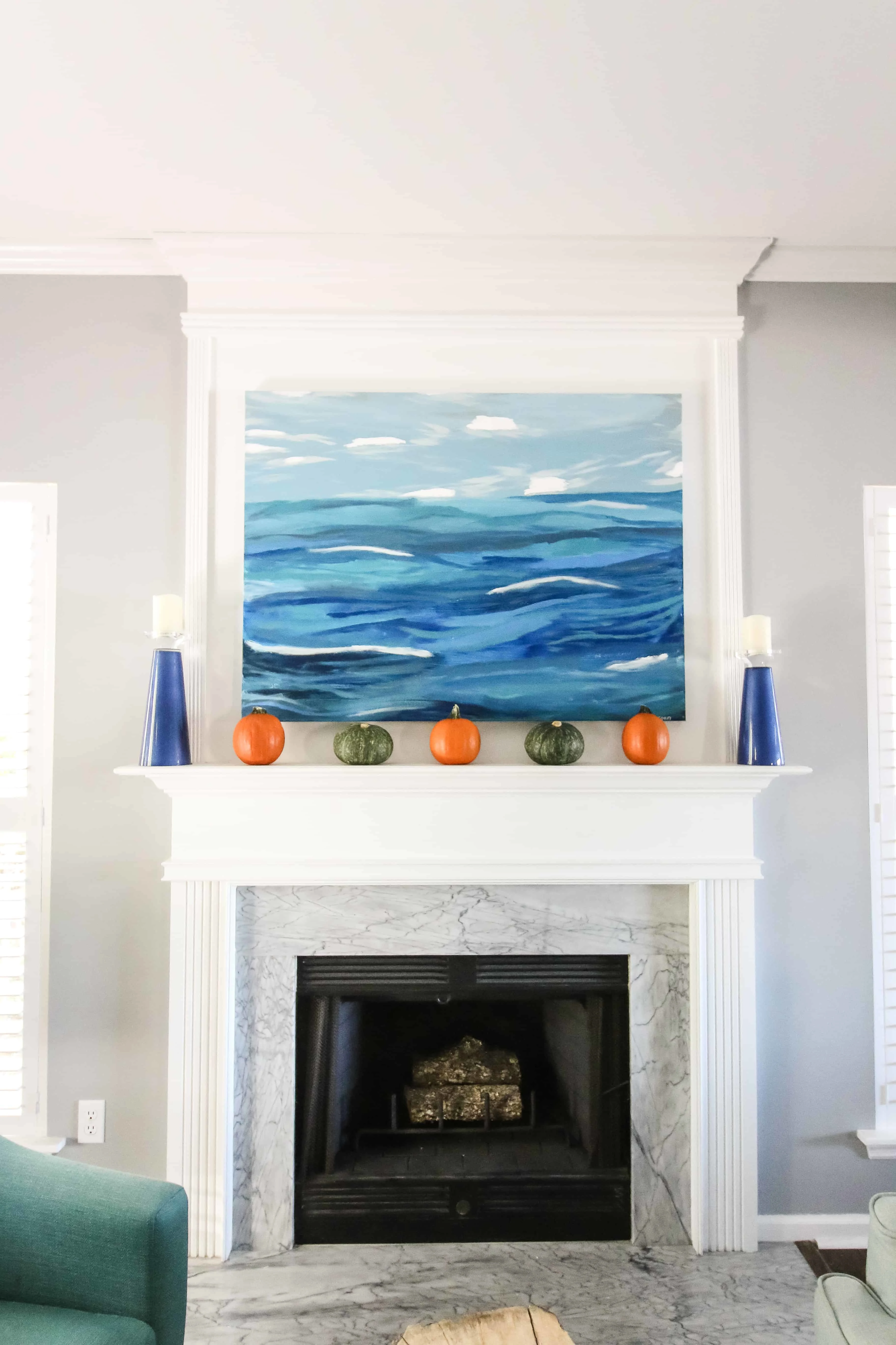 Simple Fall Mantel with pumpkins and greenery via Charleston Crafted