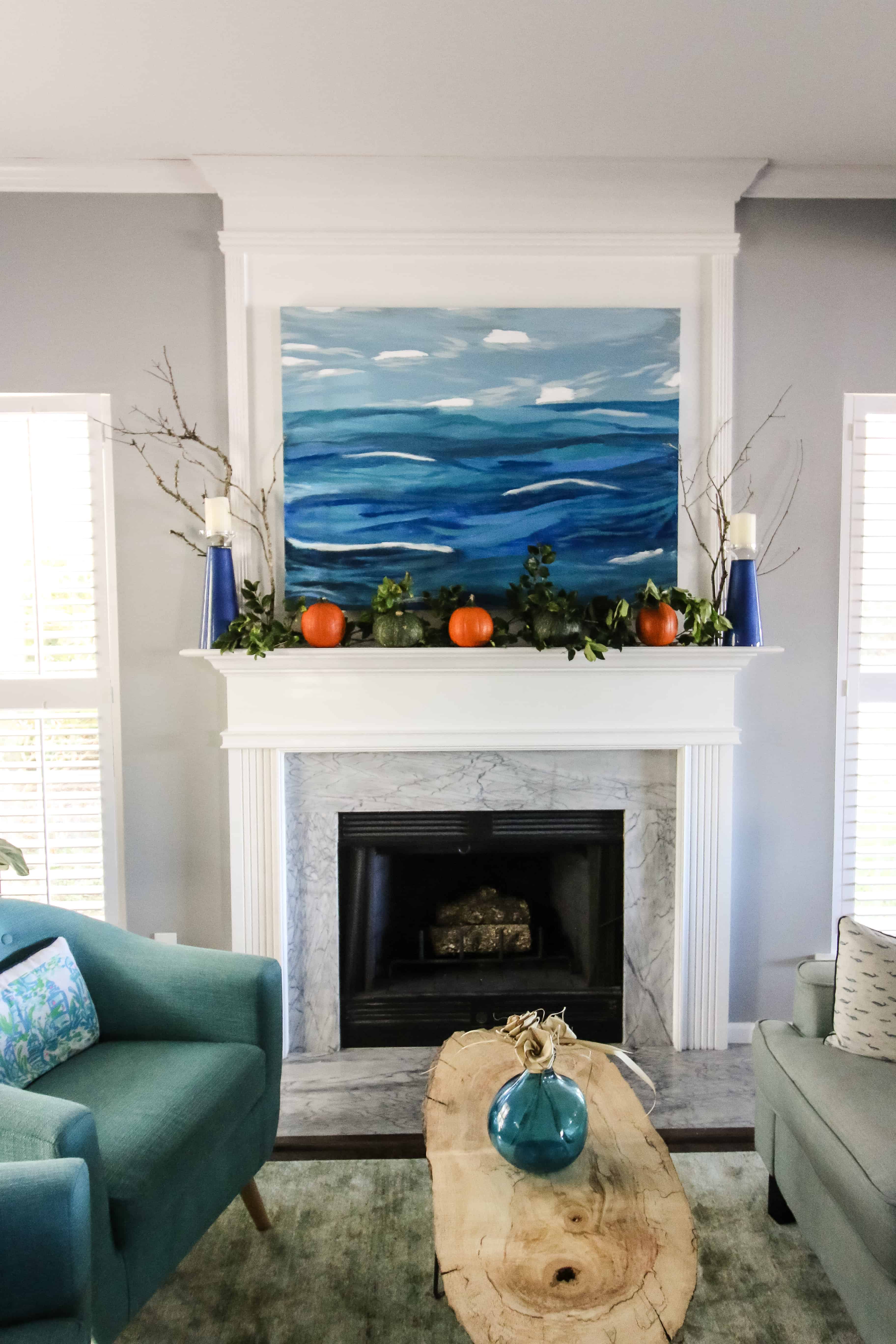 Simple Fall Mantel with pumpkins and greenery via Charleston Crafted
