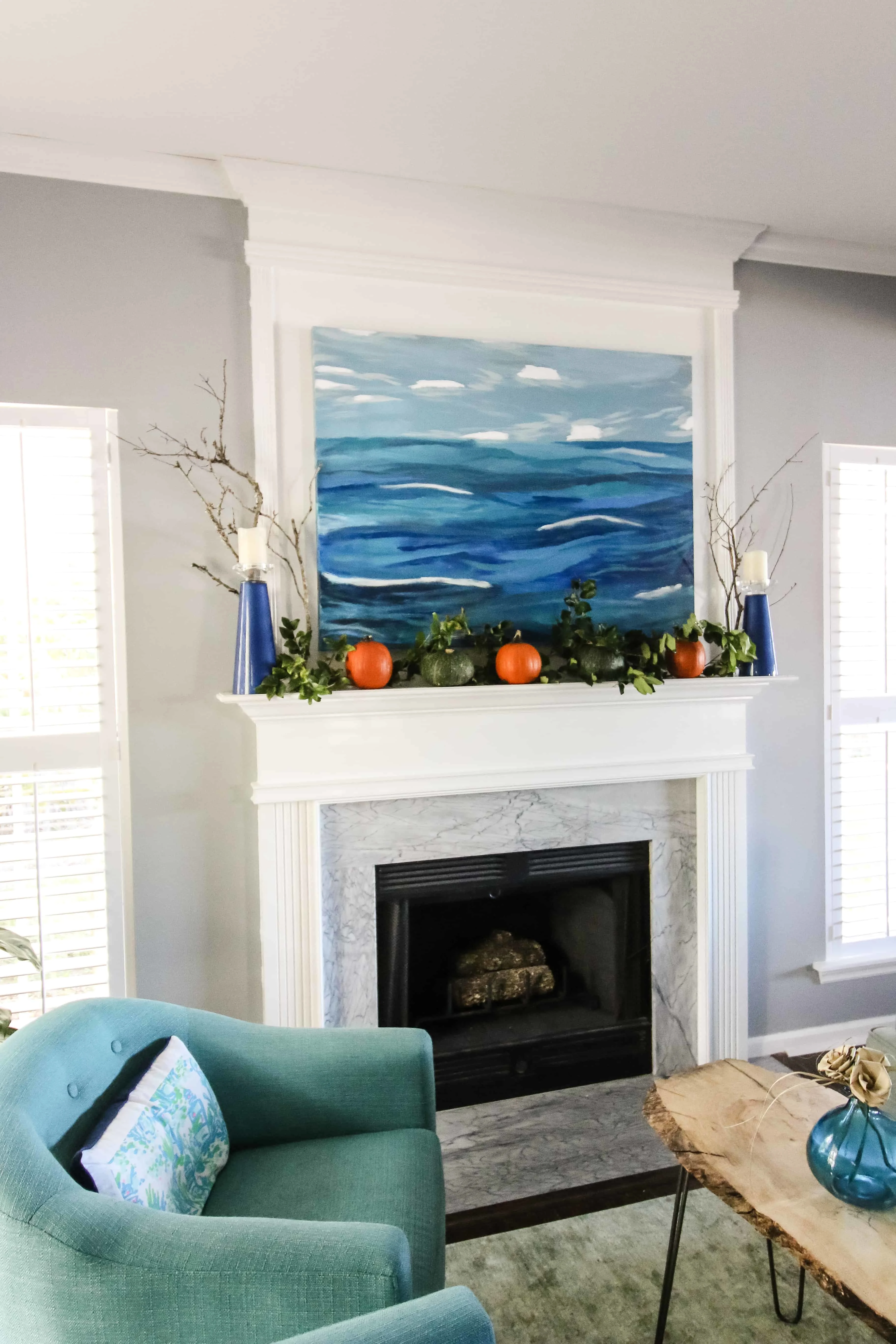 Simple Fall Mantel with pumpkins and greenery via Charleston Crafted