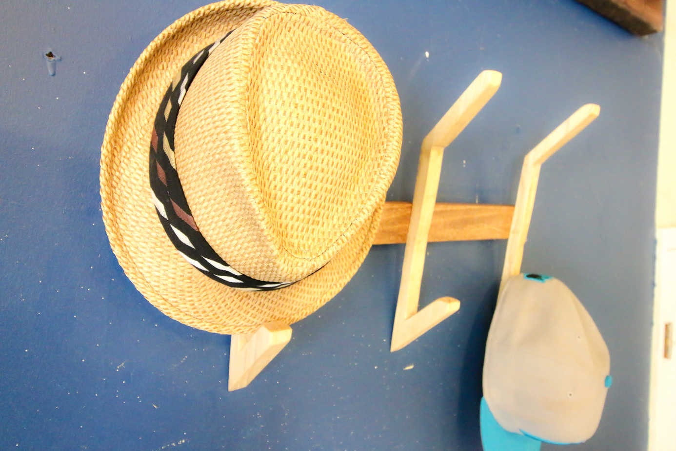 DIY hat organizer - simply use a wooden stick and some string.