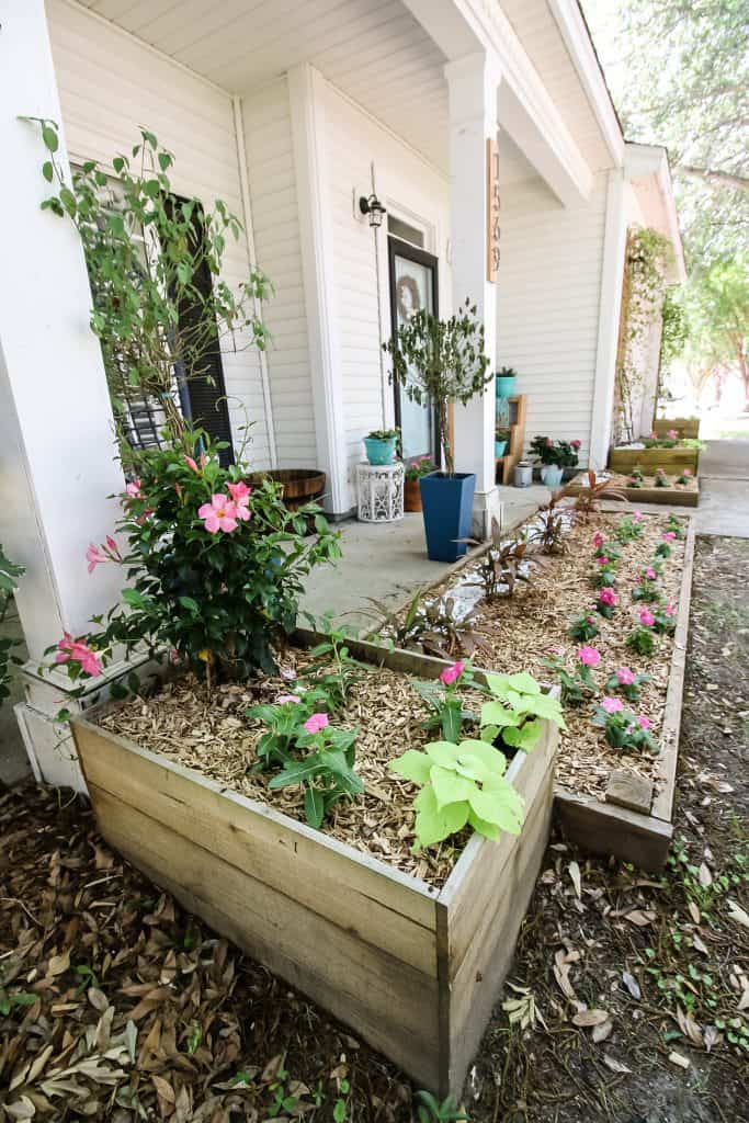 adding pebbles to a flower bed to prevent erosion