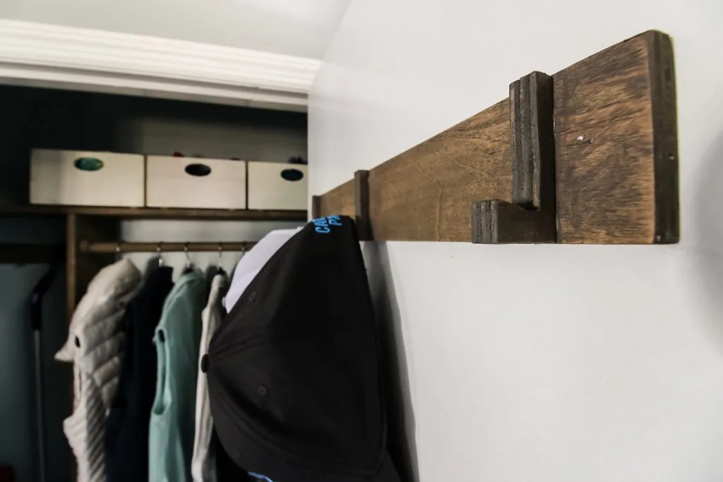 DIY wooden hooks for hats in an entrycloset