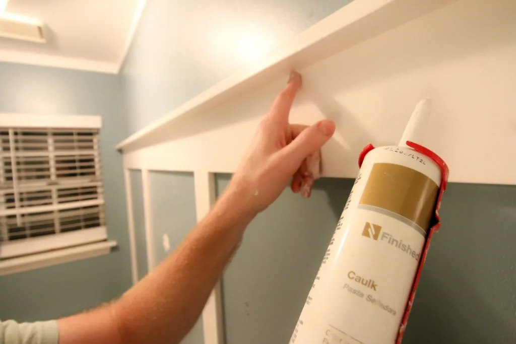 Spreading caulk with finger