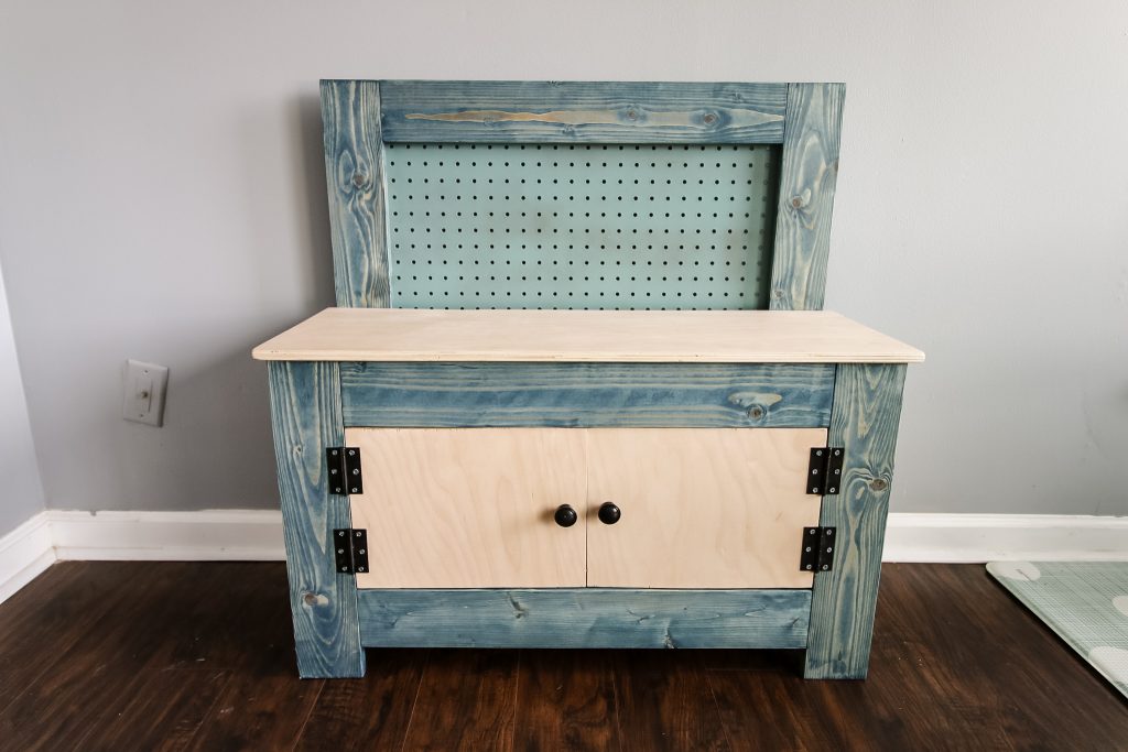 Painted pegboard on toddler workbench