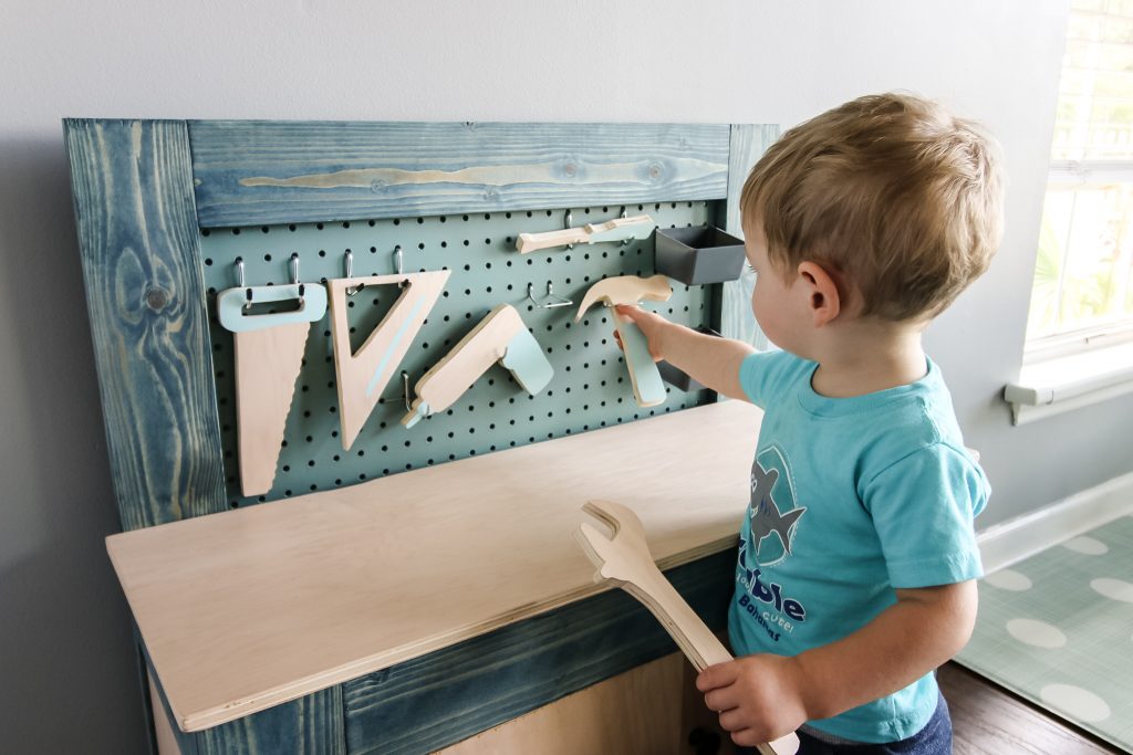 Playing with wooden tool set