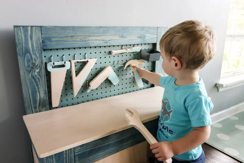 Playing with wooden tool set