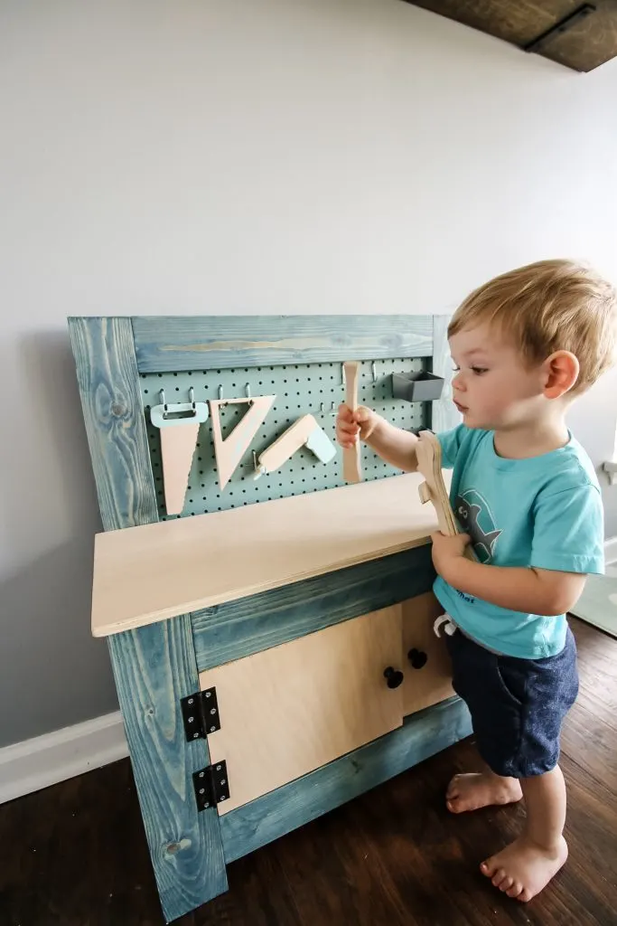 Toddler using toddler workbench