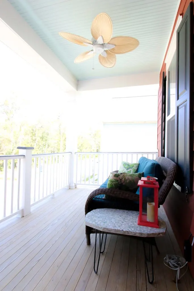 woven blade fan on haint blue porch ceiling