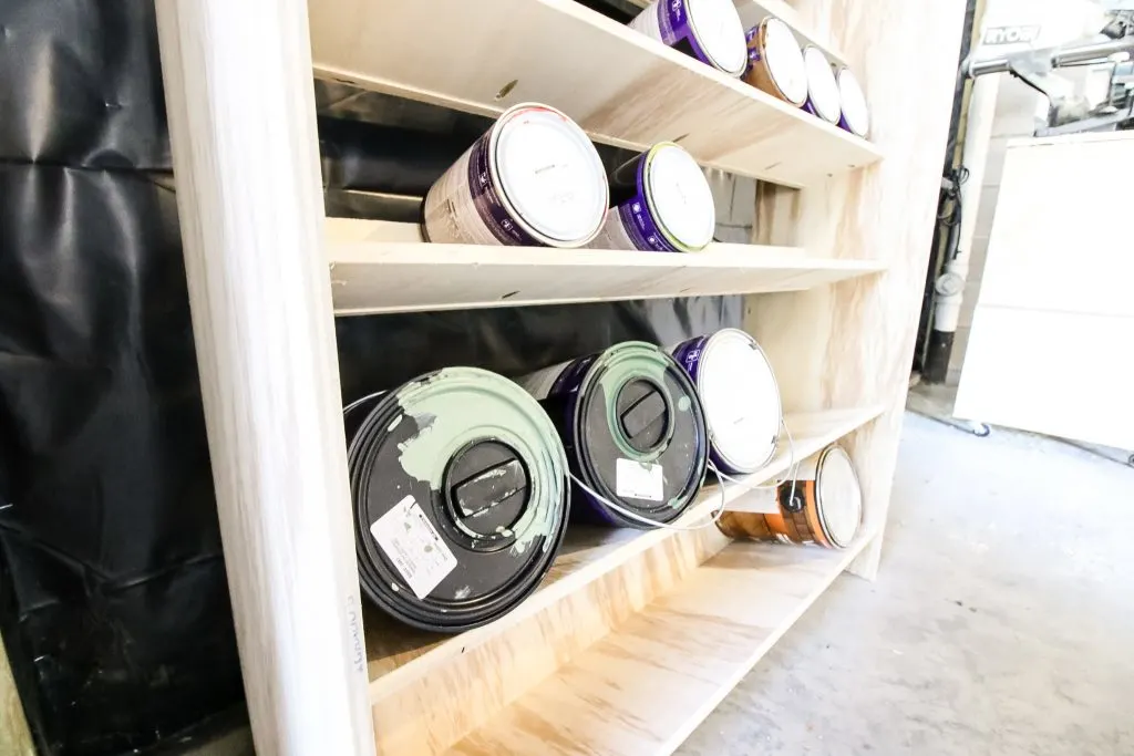 closeup of paint cans on shelf