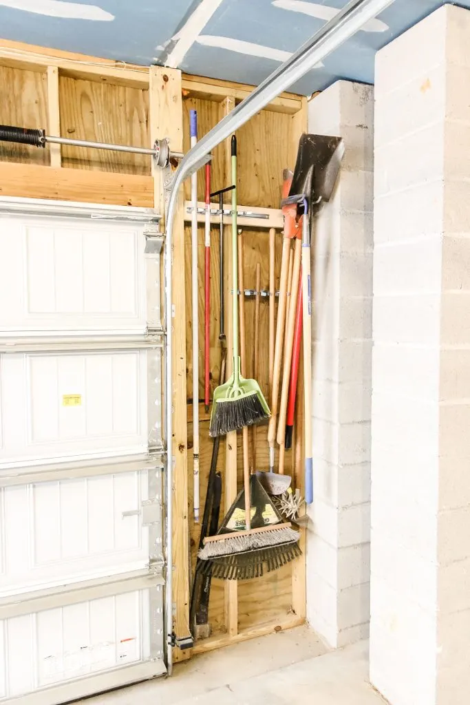 Outdoor tools in wall clips in garage