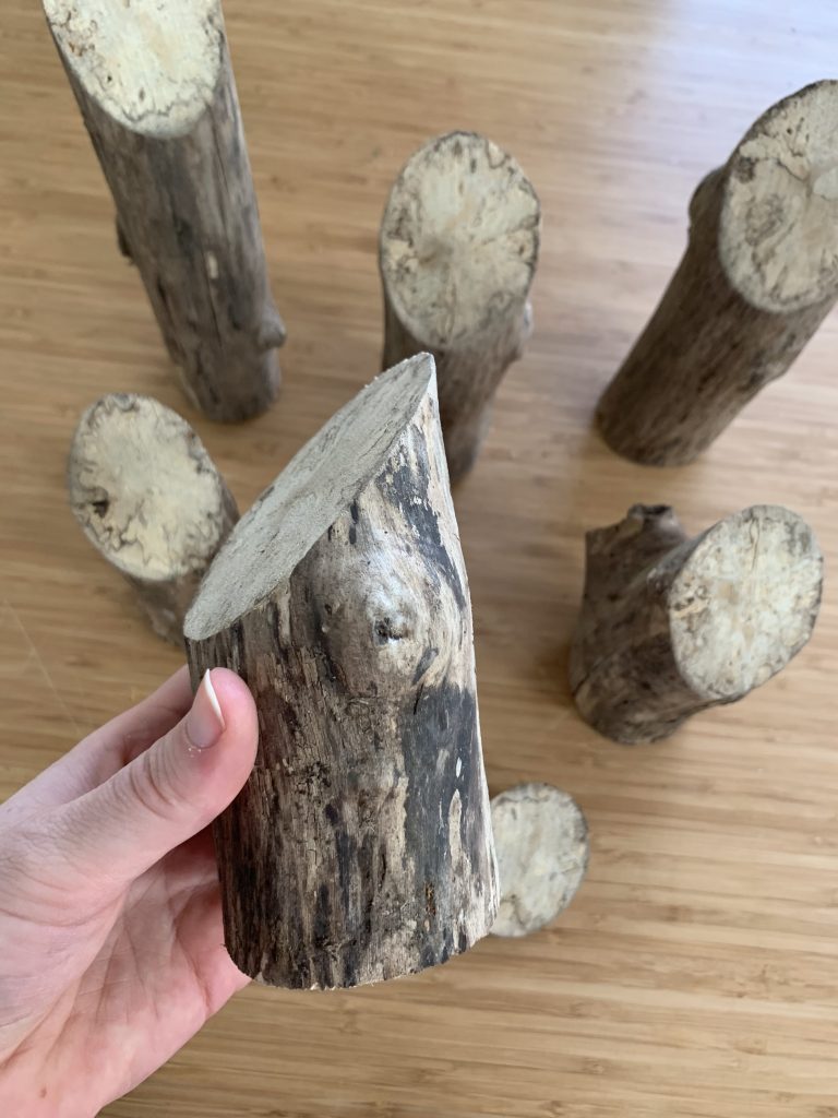 Logs cut at 45 degree angles to make santas