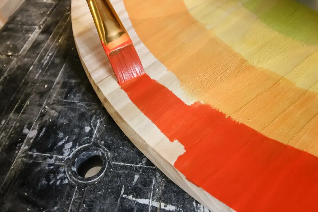 painting tabletop with a rainbow pattern