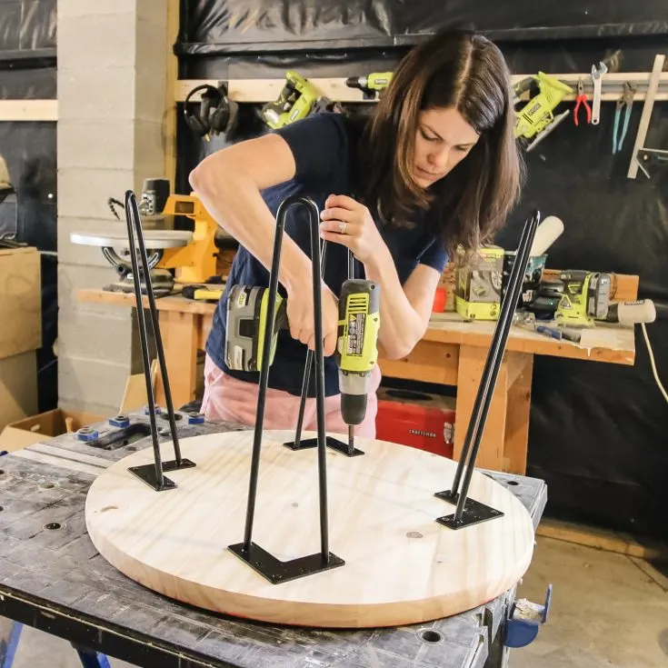 screwing hairpin legs into a round wooden tabletop