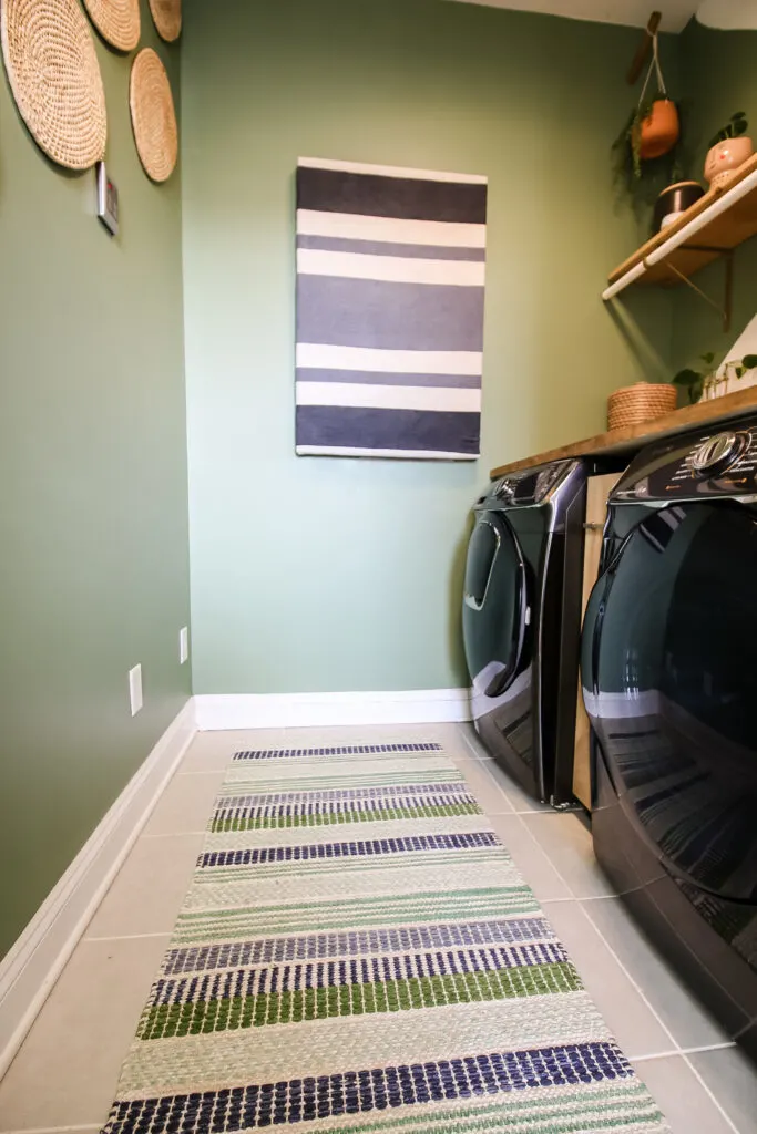 Rug hanging on wall in laundry room