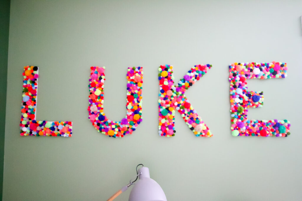 DIY pom pom letters spelling LUKE