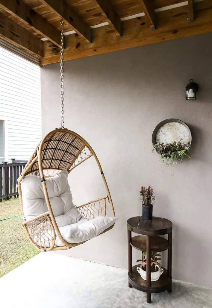 wooden side table on a covered patio
