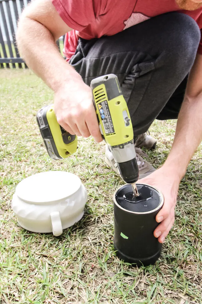 Drilling a hole for drainage in the bottom of a ceramic container to use as a pot