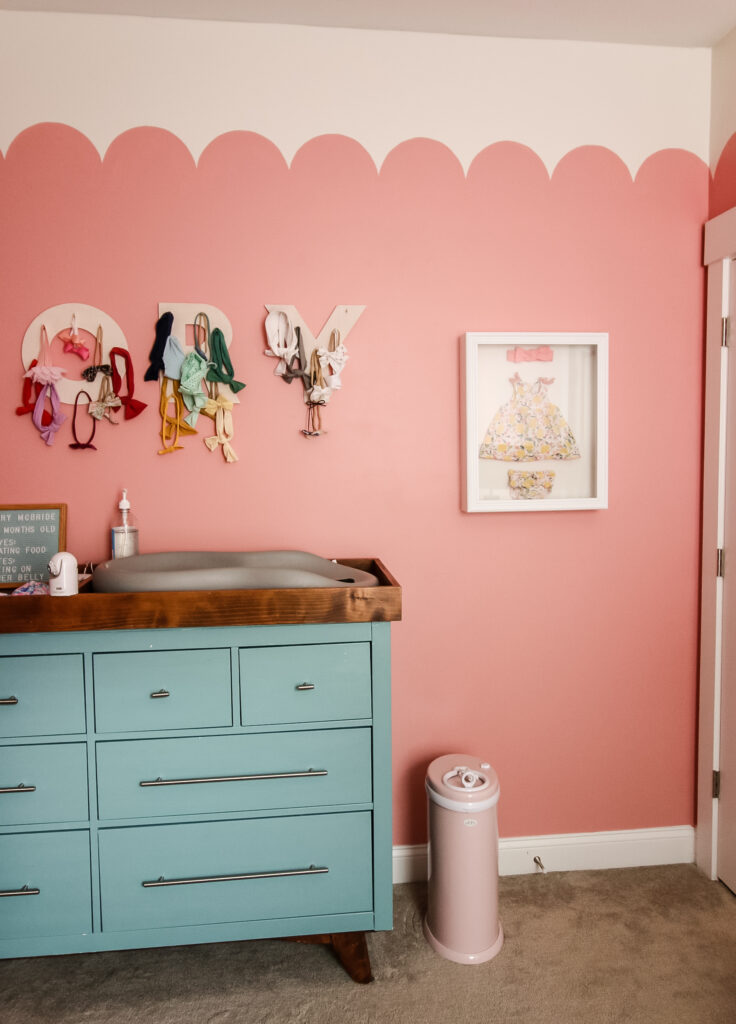 shadow box of baby items in a baby nursery