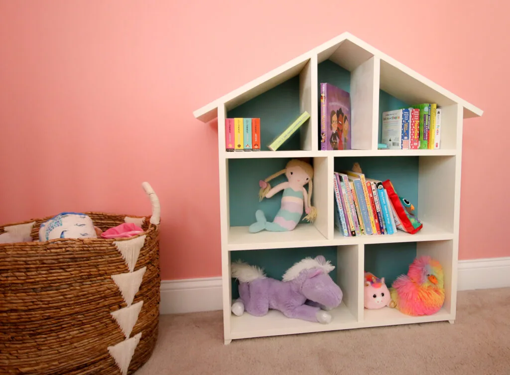 Dollhouse bookshelf with toy basket