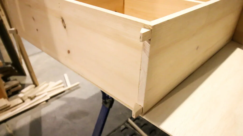 Attaching feet to base of dollhouse bookshelf