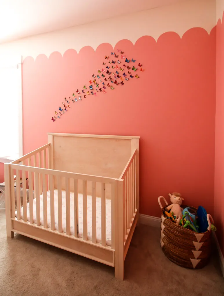 butterflies hanging on a wall over a crib