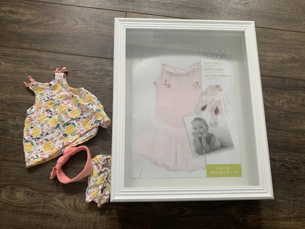 DIY baby clothes shadow box display