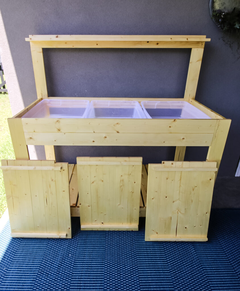 Hidden storage bins on potting bench