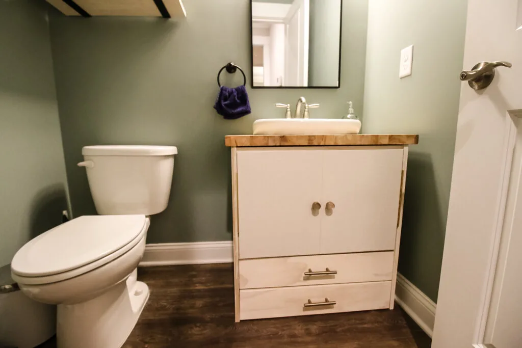 Wide shot of pedestal sink vanity in half bathroom