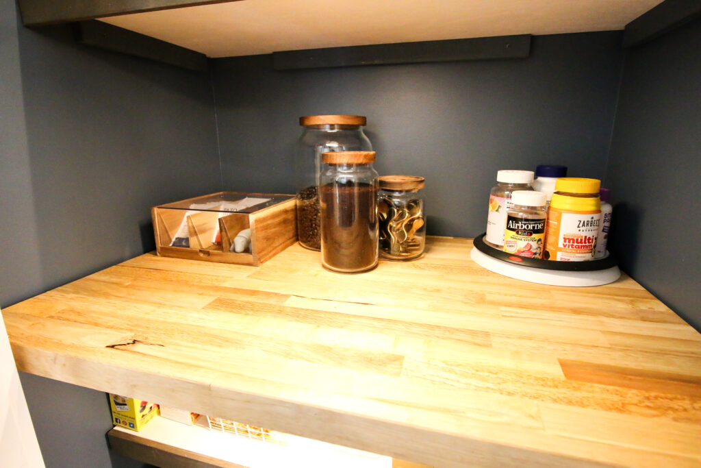 canister and tea organizer in a small pantry