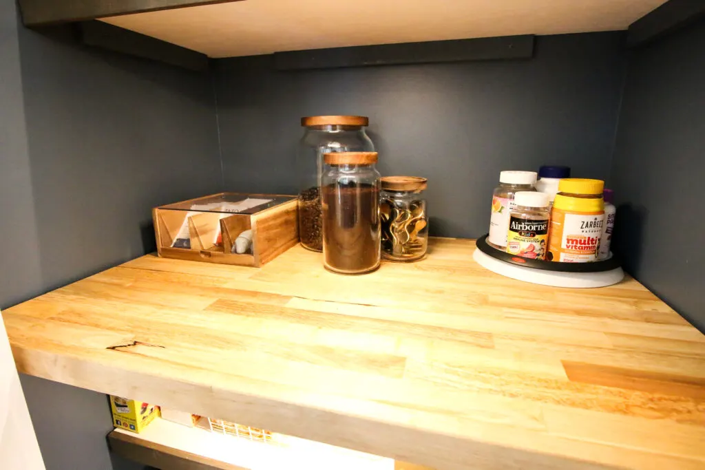 canister and tea organizer in a small pantry