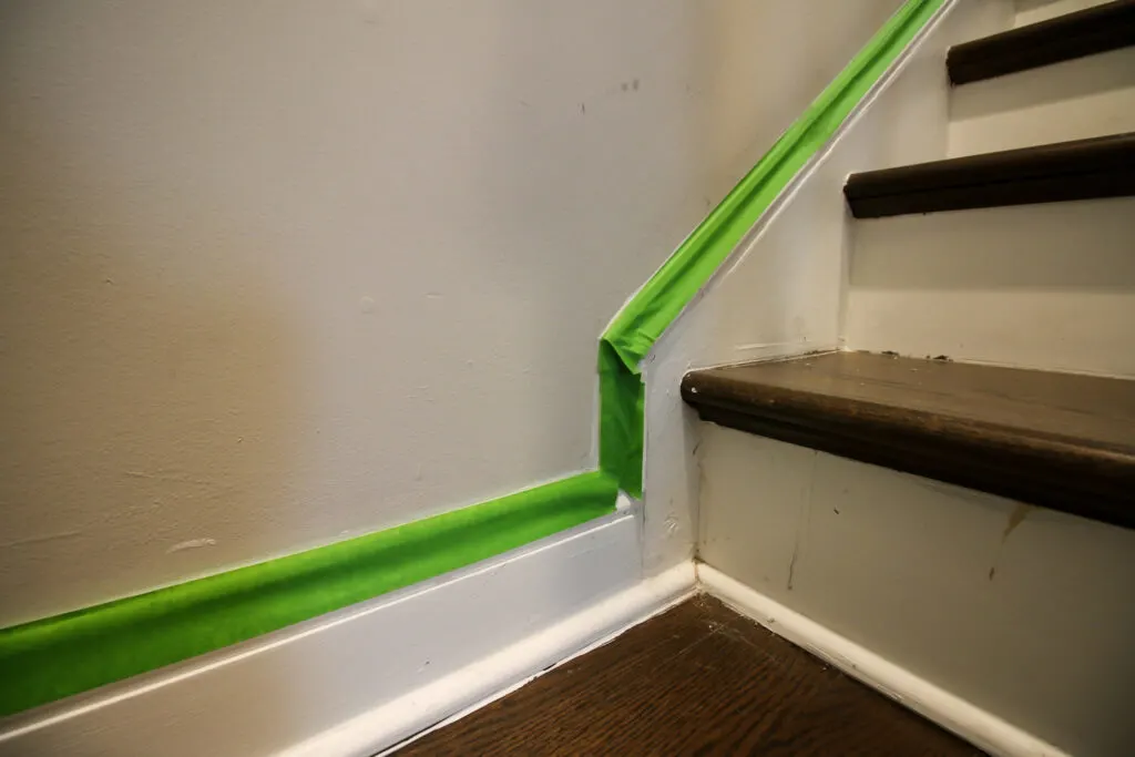 Applying painter's table to wall to paint before caulking