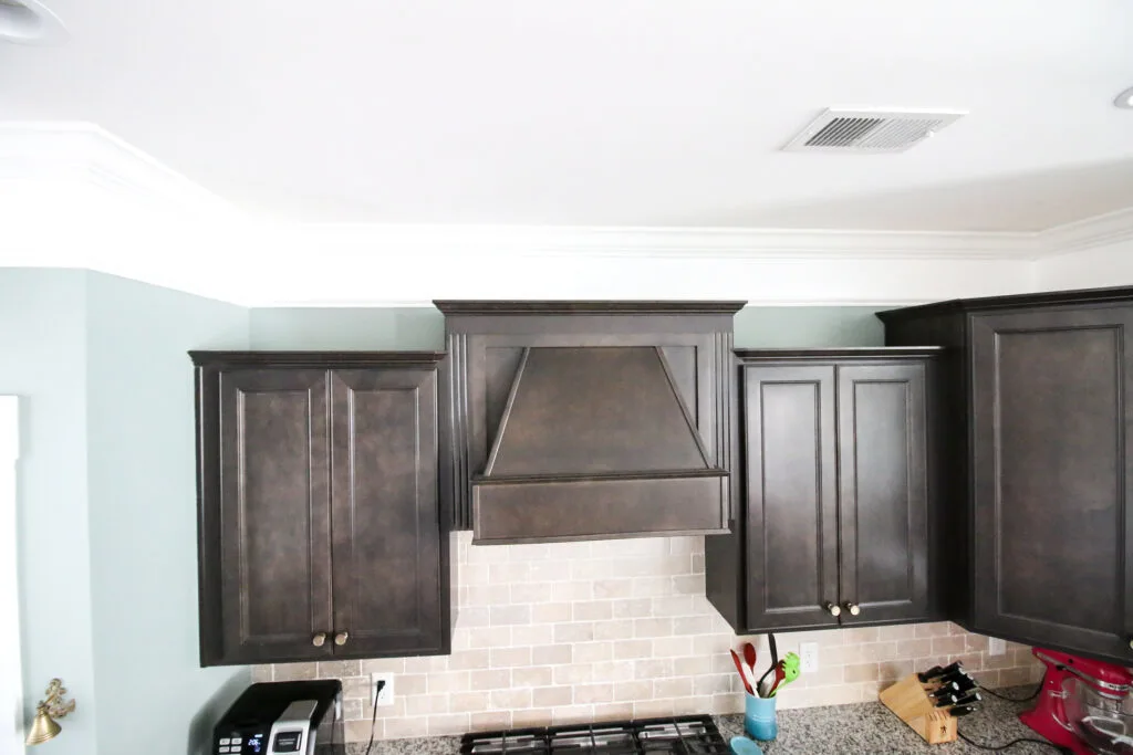 Extended crown molding above kitchen cabinets