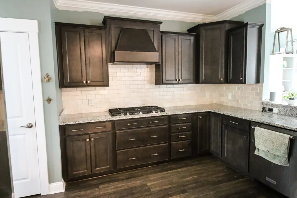 kitchen with painted travertine backsplash