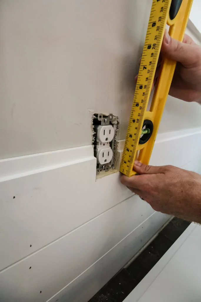 Measuring for outlet cutout on shiplap board