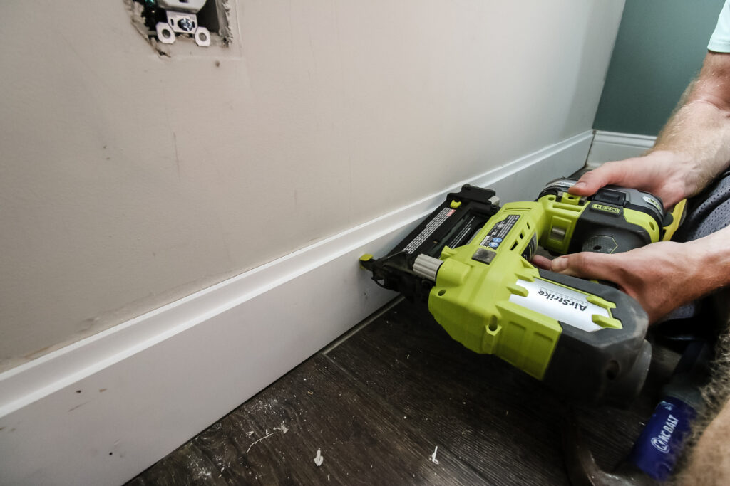 Installing first shiplap board on wall