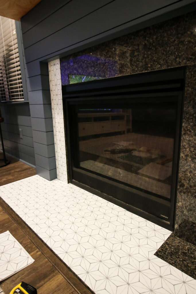 applying peel and stick tile to a fireplace