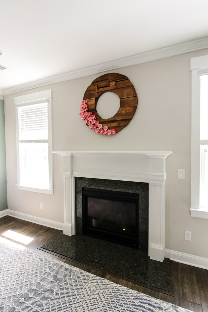 Builder grade fireplace surround and mantel before removal