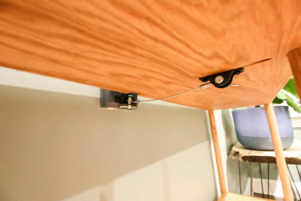 Attaching furniture anti-tip kit to underside of bookshelf