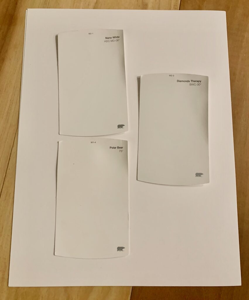 white paint samples on a white sheet of paper