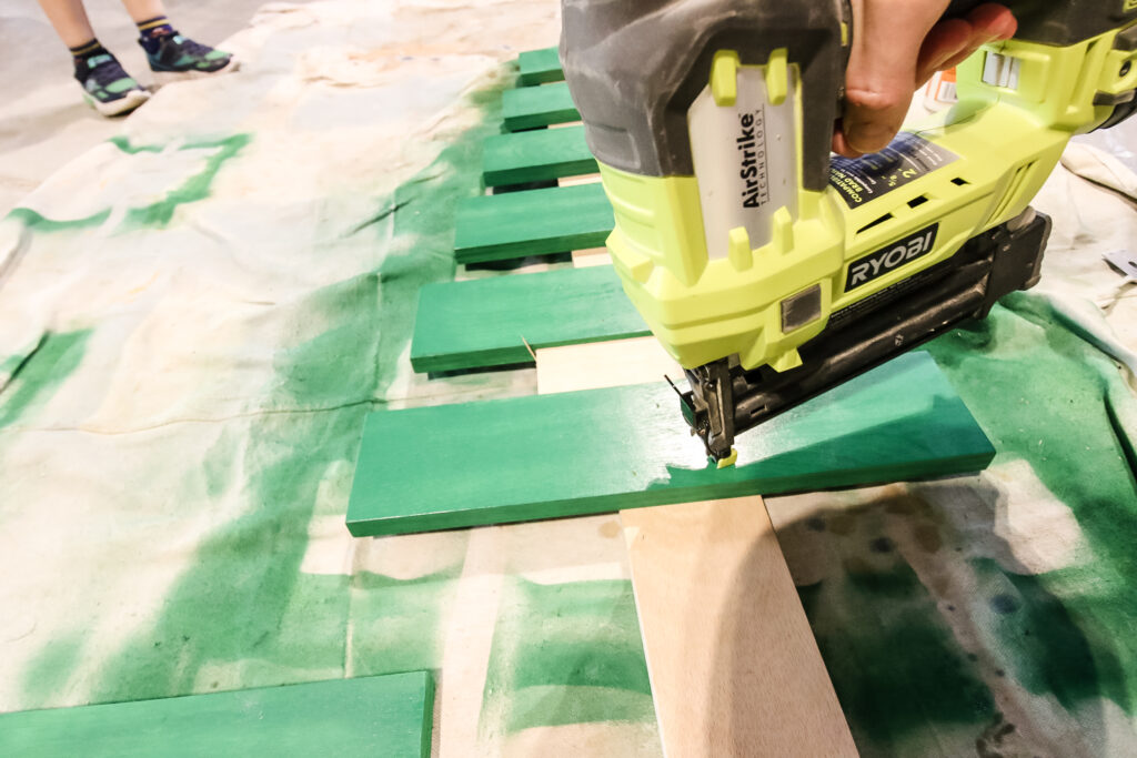 Nailing slats to wooden Christmas tree