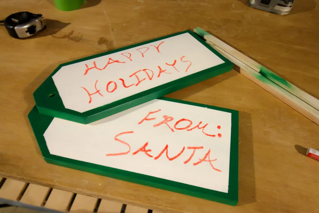 Painting message onto DIY holiday gift tag door hangers